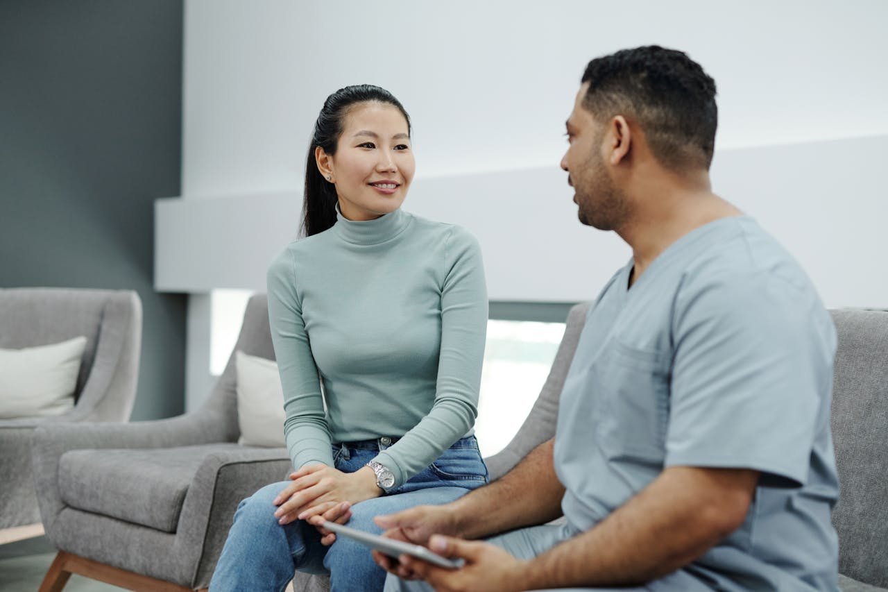 A doctor and patient engaging in a health consultation in a modern clinic setting.